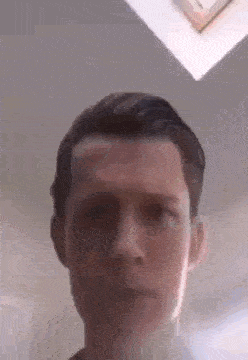 a close up of a man 's face with his eyes closed .