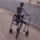a person in a wheelchair is sitting on the sidewalk .