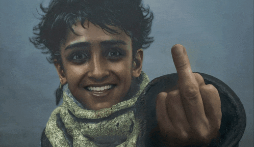 a young girl is smiling and giving the middle finger to the camera