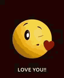 a yellow smiley face is blowing a kiss with a red heart on its nose .