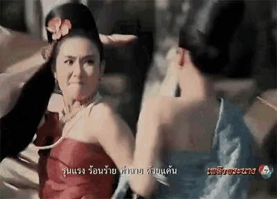 a woman in a red dress is standing next to another woman in a blue dress in a foreign language .