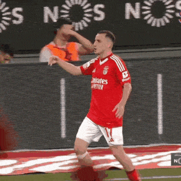 a soccer player wearing a red shirt that says " emirates better "