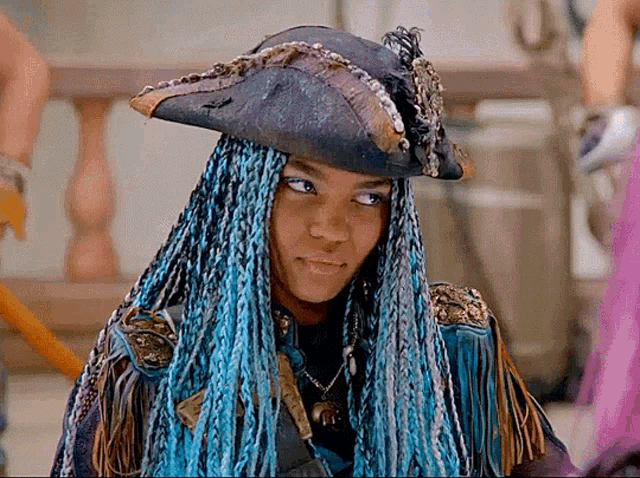 a woman with blue dreadlocks and a pirate hat
