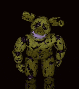 a yellow and purple stuffed animal with a sad face