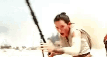 a woman is holding a sword in her hand and looking at the camera with a surprised look on her face .