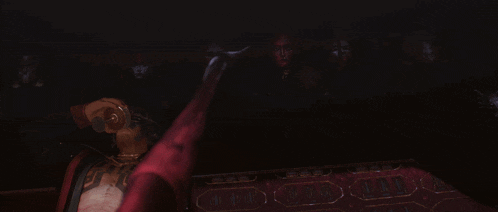 a woman with red paint on her face is surrounded by a spider