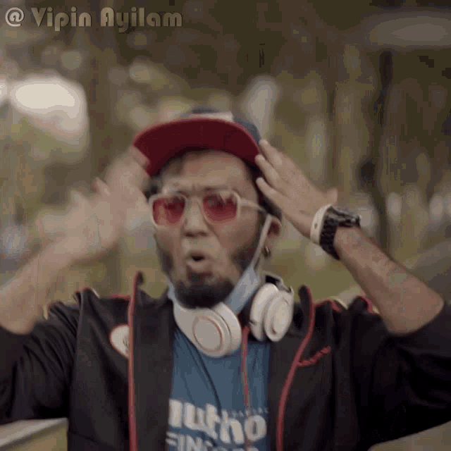 a man wearing headphones and a mask with the name vipin ayilam on the bottom right