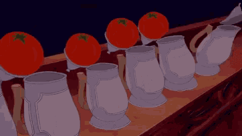 a row of mugs with tomatoes on them