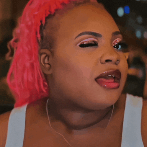 a close up of a woman with pink hair