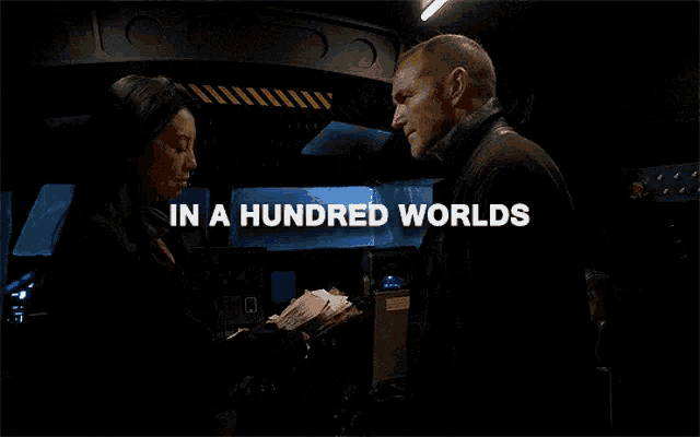 a man and a woman are standing next to each other with the words in a hundred worlds written above them