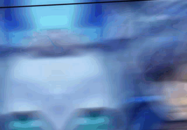 a blurry picture of a person 's face with a blue and white background