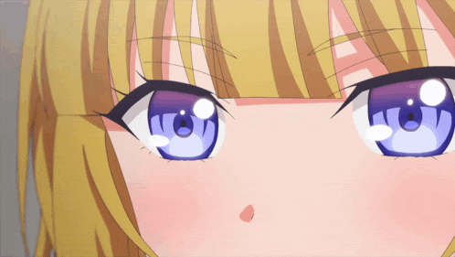 a close up of a girl 's face with blue eyes and blonde hair