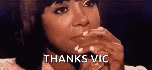 a woman is crying and saying `` thanks vic '' while holding her hand to her face .