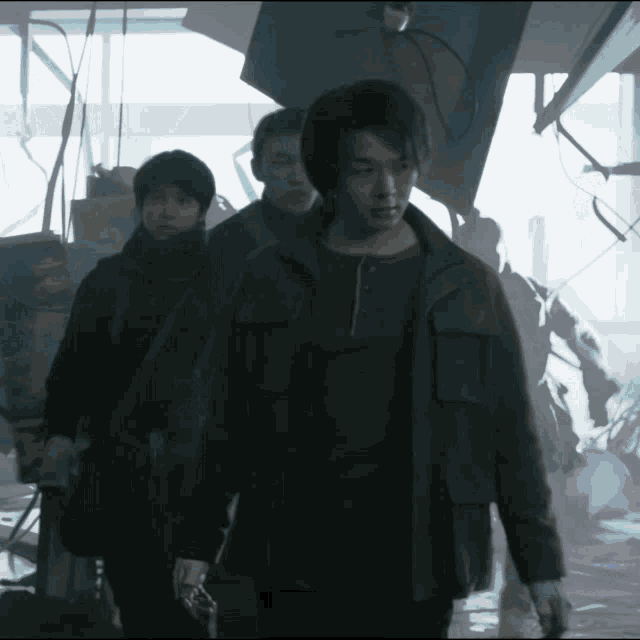 a man in a brown jacket is walking with two other people