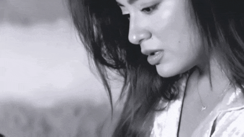 a close up of a woman 's face in a black and white photo
