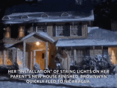 a house with string lights on it is covered in snow and ice .