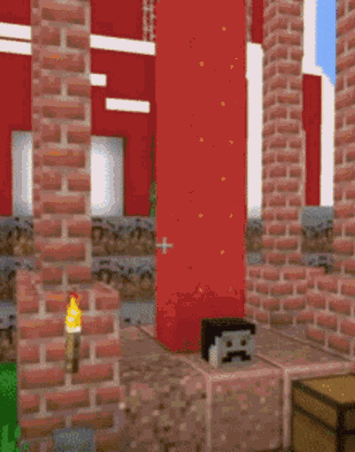 a brick wall with a torch on it in minecraft