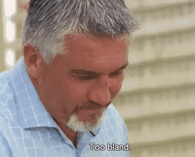 a man with gray hair and a beard is sitting down and says too bland .