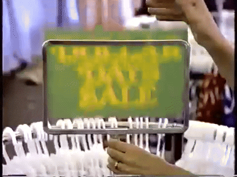 a person is holding a sign that says " sale "