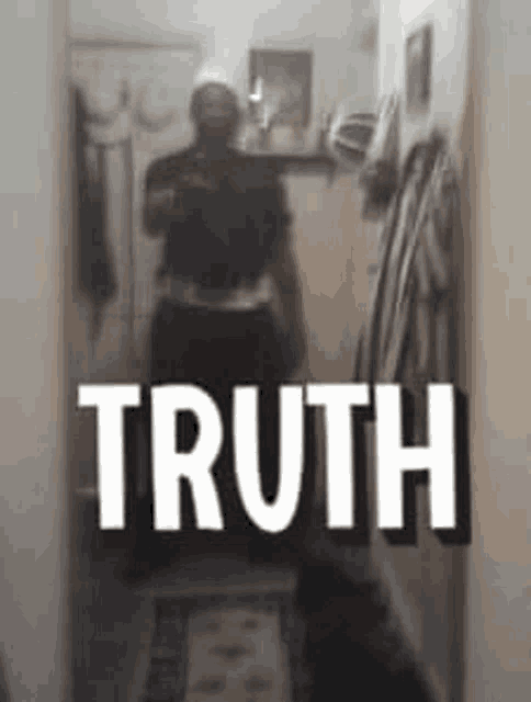 a man taking a picture of himself in a mirror with the word truth above him