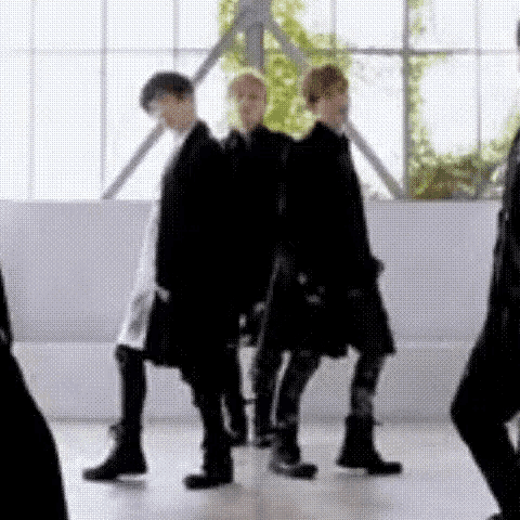a group of men are standing next to each other in a room .