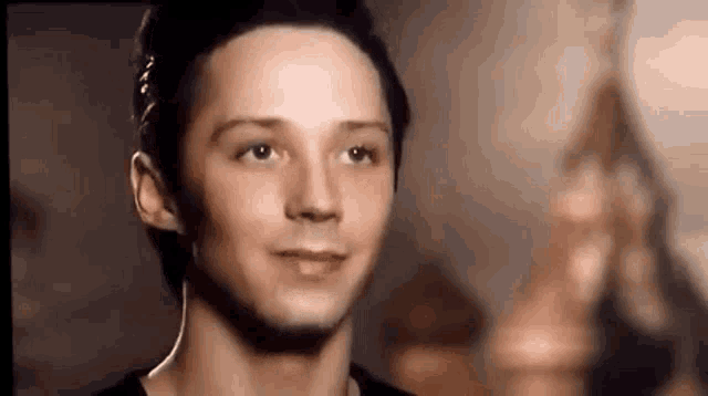 a close up of a young man 's face looking at the camera .
