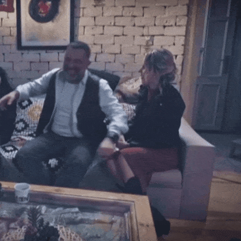 a man and a woman are sitting on a couch