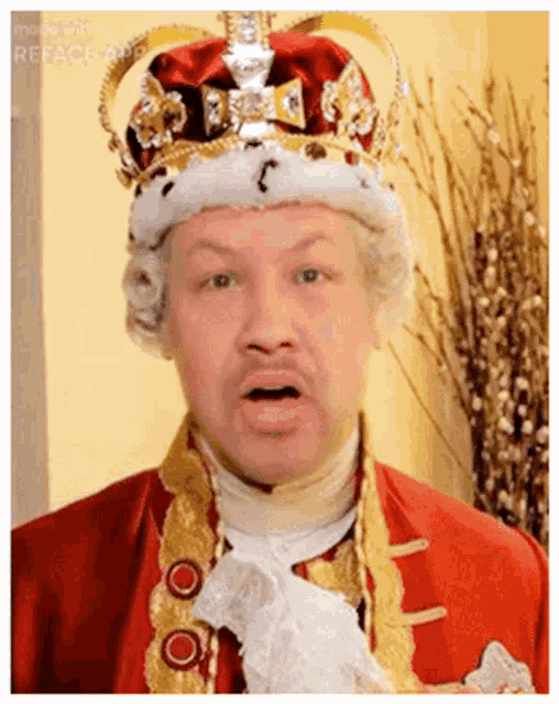 a man in a red and gold costume with a crown on his head .