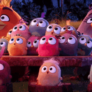a bunch of stuffed birds are sitting on a wooden bench