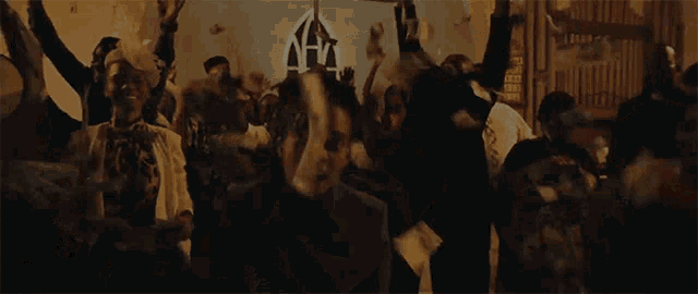 a group of people are throwing money in the air in a dark room .