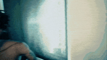 a blurry picture of a person standing in front of a wall