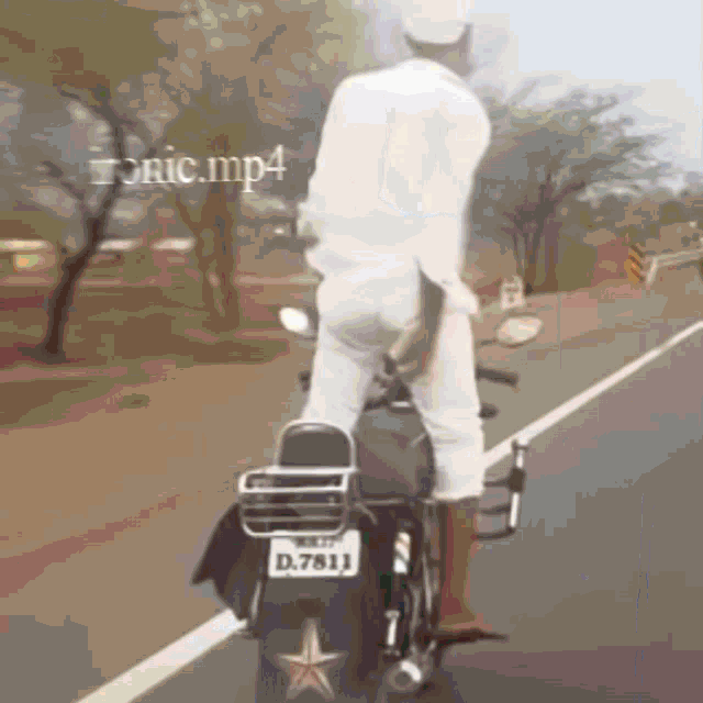 a man riding a motorcycle with a license plate that says d 7811