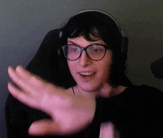 a woman wearing glasses and headphones is waving