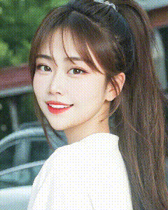a close up of a woman 's face with a ponytail .