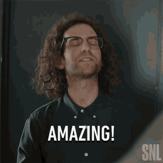 a man with curly hair and glasses says " amazing " in front of a snl logo
