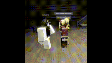 a couple of roblox characters standing next to each other on a wooden floor in a dark room .