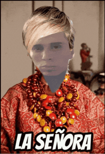 a woman wearing a red shirt and a necklace with the word la señora on it