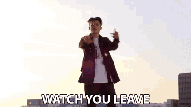 a man is dancing on a rooftop with the words watch you leave below him