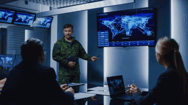 a man in military uniform is giving a presentation