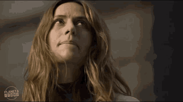 a close up of a woman 's face with the word planeta visible in the corner