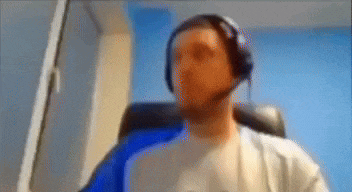 a man wearing headphones is sitting in a chair .