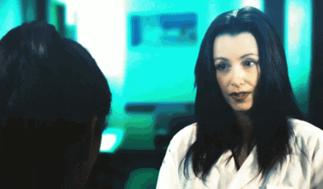 a woman in a white coat is talking to another woman