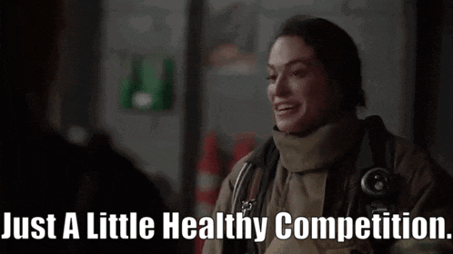 a woman in a fireman 's uniform is smiling and says just a little healthy competition