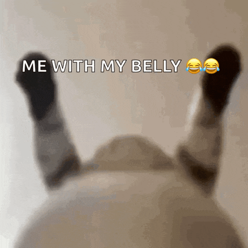 a person laying on their back with the words me with my belly written above them