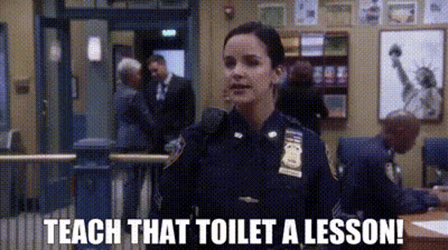 a police officer is standing in a room with the words `` teach that toilet a lesson ! ''