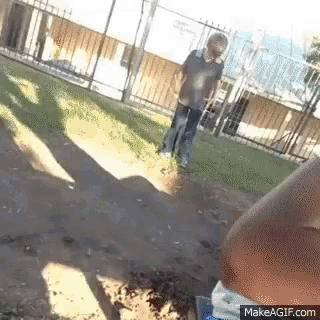 a man is walking down a dirt path with a bottle of water in front of him
