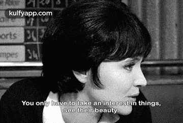 a black and white photo of a woman talking to someone .