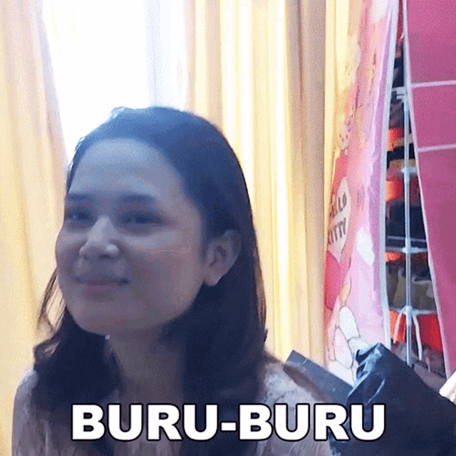 a woman says buru-buru in front of a hello kitty wall