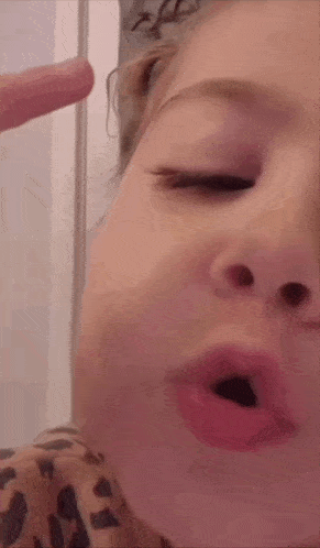a close up of a child making a funny face with her mouth open