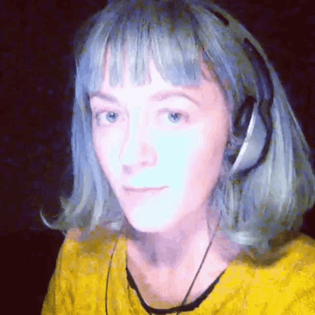 a woman wearing headphones and a yellow shirt